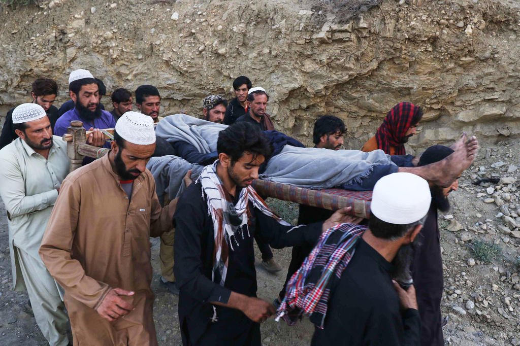 People transport the body of a miner recovered after an explosion inside a coal mine on the outskirts of Quetta, in southwest Pakistan, Thursday, July 30, 2026. (AP Photo/Fazal Tawab)
