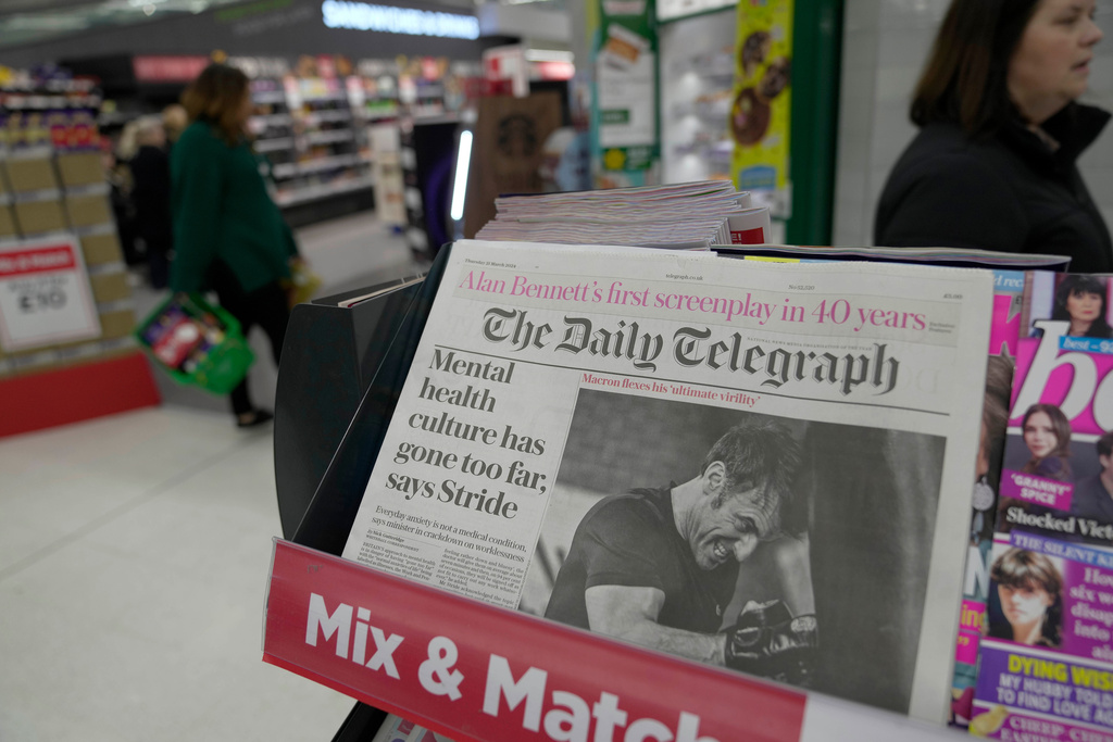 FILE -The Daily Telegraph newspaper with the front page of French President Emanuel Macron is seen at a supermarket in London, March 21, 2024. (AP Photo/Kin Cheung, File)