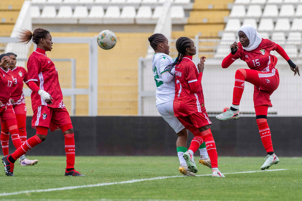 Sudan's U-17 women's national team players, in red, defend the ball during a soccer match against Comoros, during qualifiers for the 2028 Los Angeles Summer Olympics, in Casablanca, Morocco, Monday, June 8, 2026. (AP Photo)