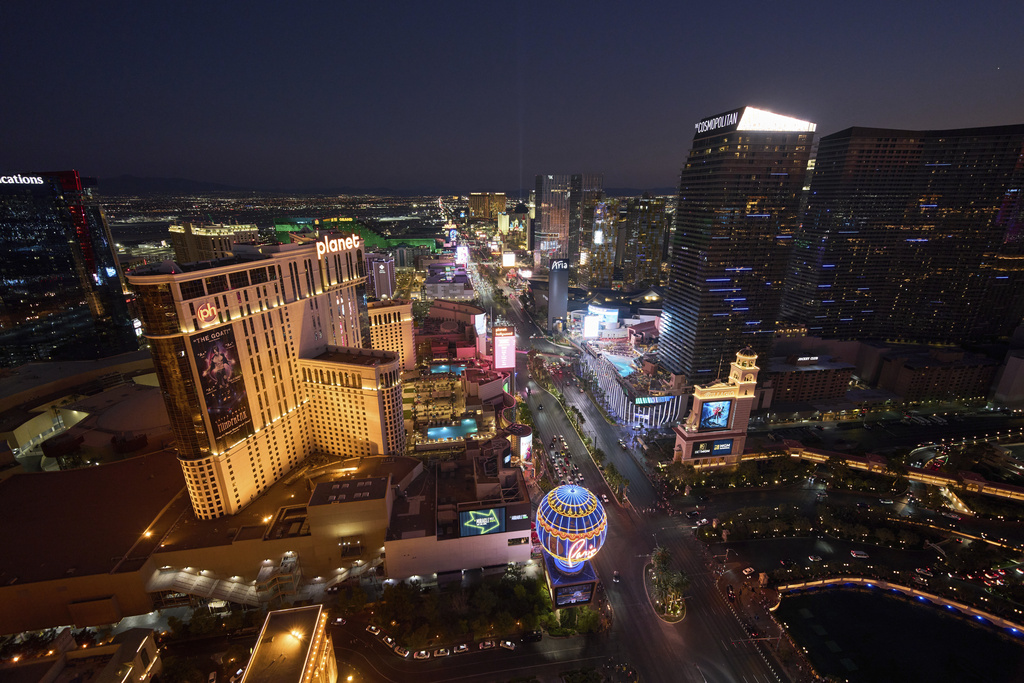 Cars drive along the Las Vegas Strip, Saturday, Aug. 2, 2025, in Las Vegas. (AP Photo/John Locher)