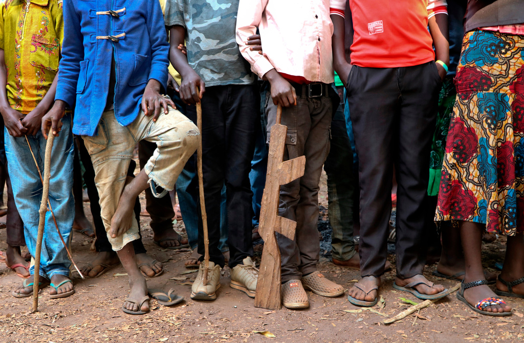 FILE - In this Feb. 7, 2018 file photo, former child soldiers stand in line waiting to be registered with UNICEF to receive a release package, in Yambio, South Sudan. (AP Photo/Sam Mednick, File)