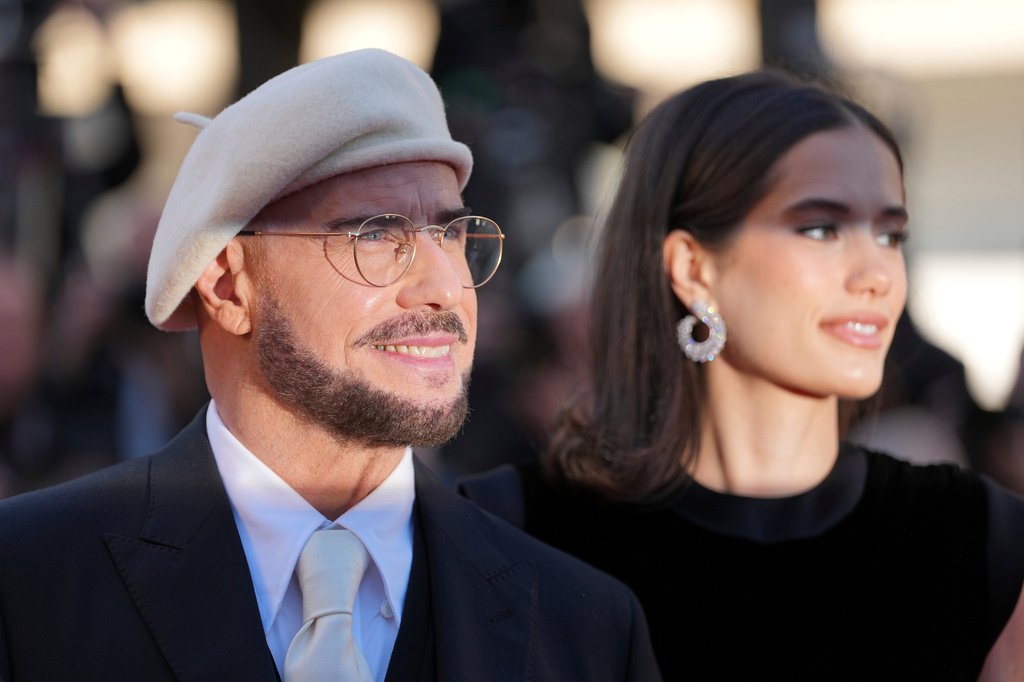 John Travolta, left, and Ella Bleu Travolta pose for photographers upon arrival at the premiere of the film 'Karma' at the 79th international film festival, Cannes, southern France, Friday, May 15, 2026. (AP Photo/Andreea Alexandru)