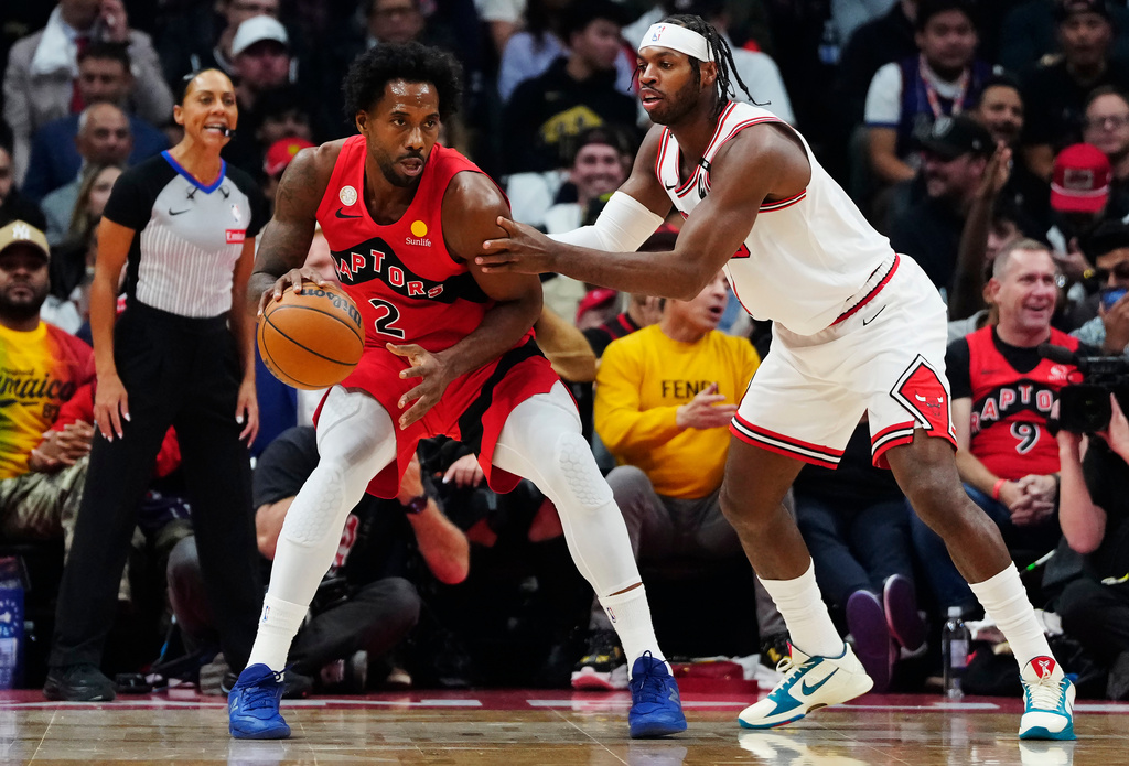 Toronto Raptors' Kawhi Leonard (2) protects the ball from Chicago Bulls' Buddy Hield (7) during the first half of an NBA basketball game in Toronto, Wednesday, Oct. 21, 2026. (Frank Gunn/The Canadian Press via AP)