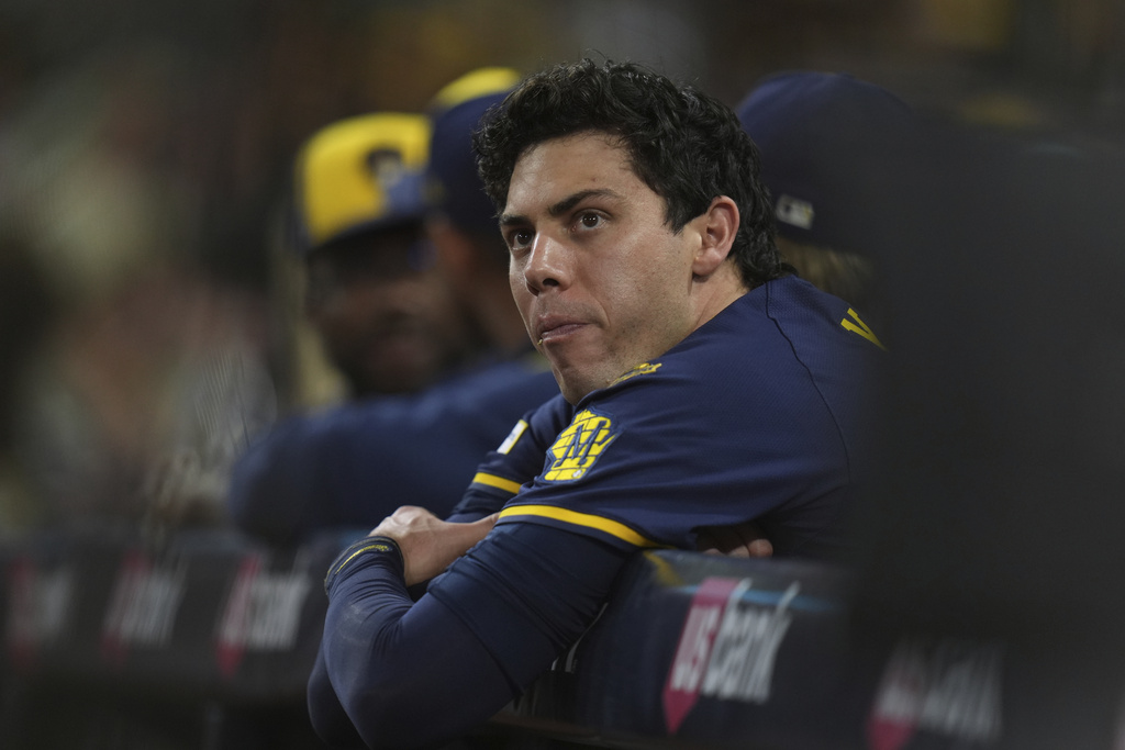 Milwaukee Brewers designated hitter Christian Yelich looks on from dugout during the second inning of a baseball game against the San Diego Padres Monday, Sept. 22, 2025, in San Diego. (AP Photo/Gregory Bull)