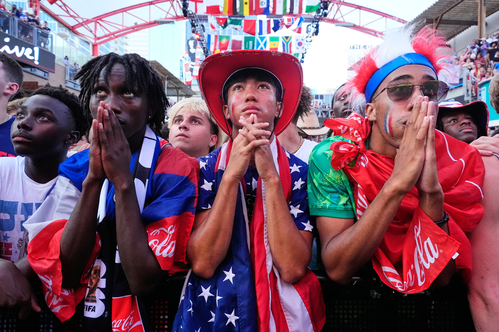 Fans watch a World Cup round of 16 soccer match between the United States and Belgium at the KC Live! entertainment district Monday, July 6, 2026, in Kansas City, Mo. (AP Photo/Charlie Riedel)
