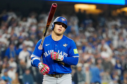 Toronto Blue Jays' Daulton Varsho (5) tosses his bat after getting hit by a pitch during the 13th inning in Game 3 of baseball's World Series, Monday, Oct. 27, 2025, in Los Angeles. (Frank Gunn/The Canadian Press via AP) Toronto Blue Jays' Daulton Varsho (5) tosses his bat after getting hit by a pitch during the 13th inning in Game 3 of baseball's World Series, Monday, Oct. 27, 2025, in Los Angeles. (Frank Gunn/The Canadian Press via AP)