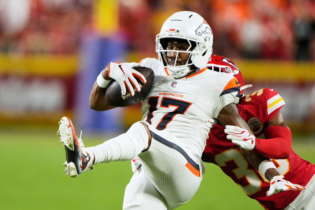 Denver Broncos wide receiver Jaylen Waddle (17) is brought down by Kansas City Chiefs cornerback L'jarius Sneed (38) after catching a pass during the first half of an NFL football game Monday, Sept. 14, 2026, in Kansas City, Mo. (AP Photo/Charlie Riedel)