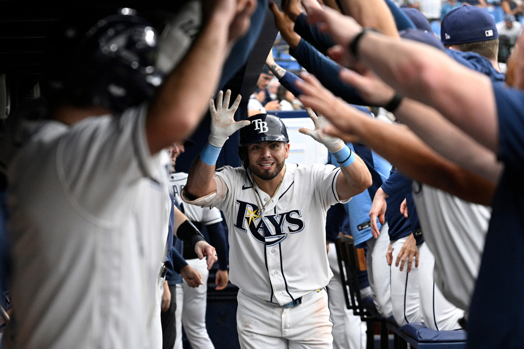 Tampa Bay Rays' Jonathan Aranda, center, is congratulated by teammates in the dugout after hitting a two-run home run during the eighth inning of a baseball game against the Seattle Mariners, Sunday, July 12, 2026, in St. Petersburg, Fla. (AP Photo/Phelan M. Ebenhack)