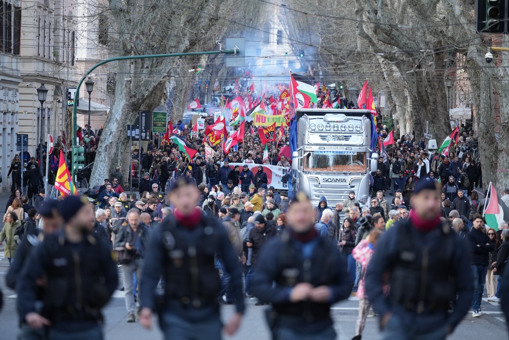People take part in a national demonstration against the war in Iran and the March 22 referendum on the Italian justice system, in Rome, Saturday, March 14, 2026. (AP Photo/Andrew Medichini)