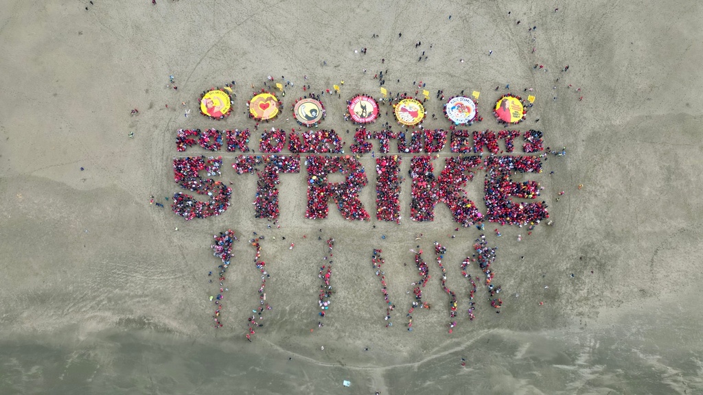 Hundreds of San Francisco teachers form a human banner spelling "STRIKE" on Ocean Beach on the third day of a district-wide strike over wages, benefits and other issues, Wednesday, Feb. 11, 2026. (AP Photo/Terry Chea)