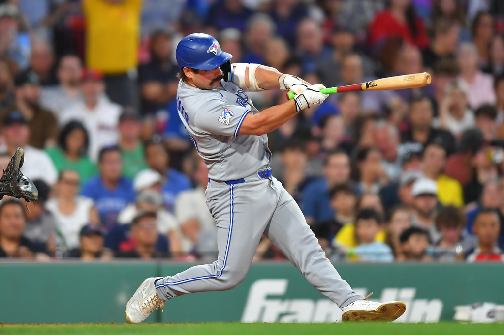 Toronto Blue Jays' Davis Schneider hits a one-run double allowing Kazuma Okamoto to score in the sixth inning of a baseball game against the Boston Red Sox, Tuesday, June 16, 2026, in Boston. (AP Photo/Steven Senne)