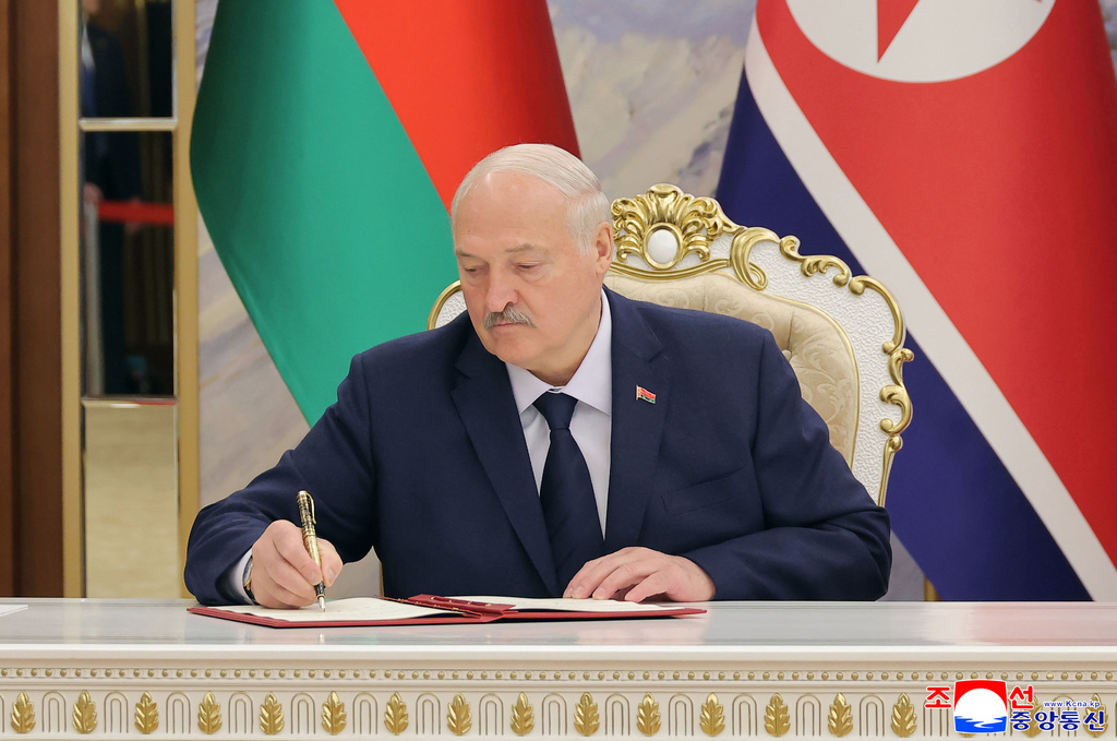 In this photo provided by the North Korean government, Belarus’ President Alexander Lukashenko signs a document in Pyongyang, North Korea Thursday, March 26, 2026. Independent journalists were not given access to cover the event depicted in this image distributed by the North Korean government. The content of this image is as provided and cannot be independently verified. Korean language watermark on image as provided by source reads: "KCNA" which is the abbreviation for Korean Central News Agency. (Korean Central News Agency/Korea News Service via AP)