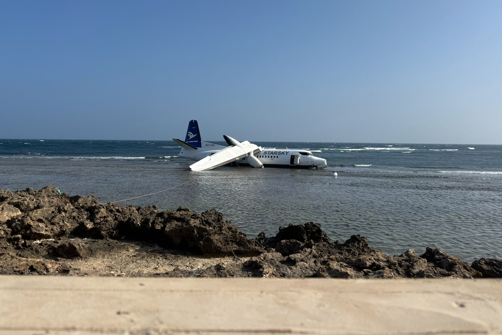 CORRECTS THE PHOTOGRAPHER'S NAME - An aircraft carrying up to 50 people on the shoreline after veering off the runway during an emergency crash-landing at Somalia's main airport in Mogadishu, Somalia, Tuesday, Feb. 10, 2026. (AP Photo/Mohamed Sheikh Nor)