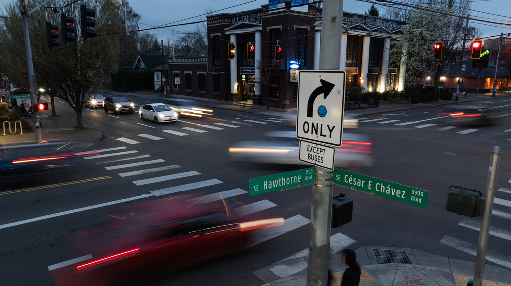 Vehicles cross Southeast César E Chávez Boulevard on Wednesday, March 18, 2026, in Portland, Ore. (AP Photo/Jenny Kane)