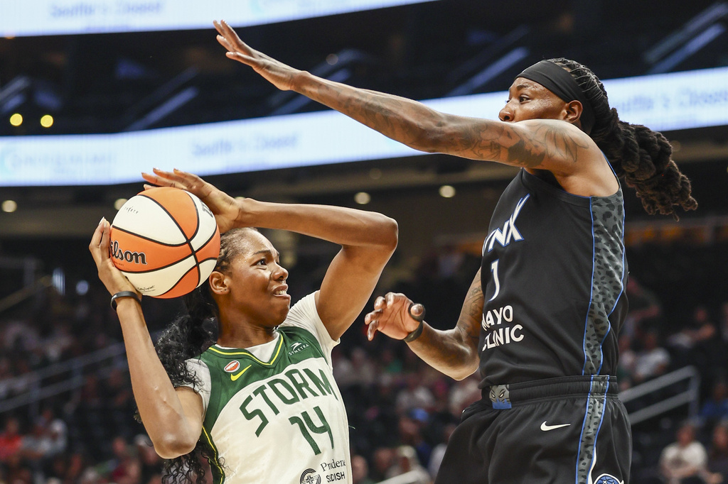 Seattle Storm center Dominique Malonga (14) looks to shoot as Minnesota Lynx forward Natasha Howard defends during a WNBA basketball game, Wednesday afternoon, July 22, 2026, in Seattle. (Kevin Clark/The Seattle Times via AP)