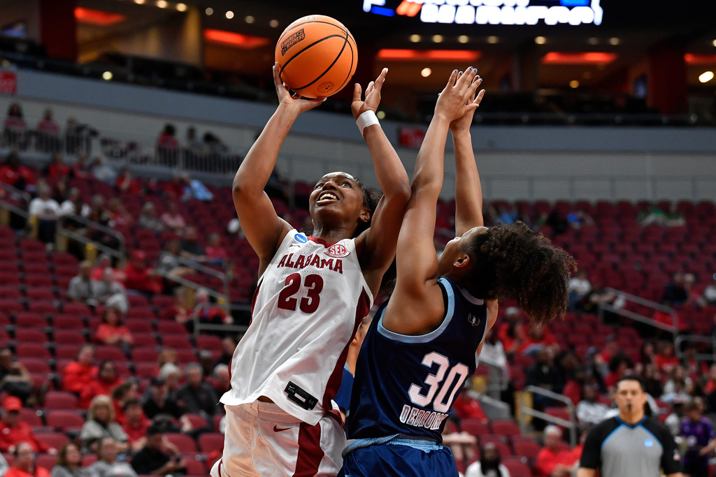 Alabama guard Jessica Timmons (23) shoots over Rhode Island guard Ines Debroise (30) during the first half in the first round of the NCAA college basketball tournament, Saturday, March 21, 2026 in Louisville, Ky. (AP Photo/Timothy D. Easley)