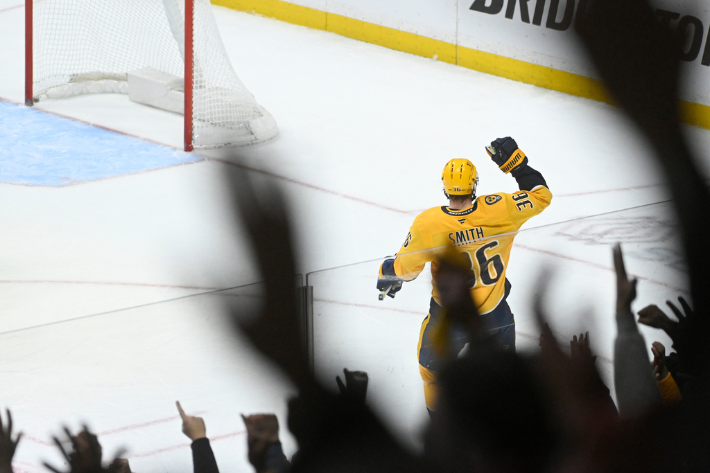 Nashville Predators left wing Cole Smith (36) and fans react after he scored against the Ottawa Senators during the third period of an NHL hockey game Thursday, Jan. 22, 2026, in Nashville, Tenn. (AP Photo/John Amis)
