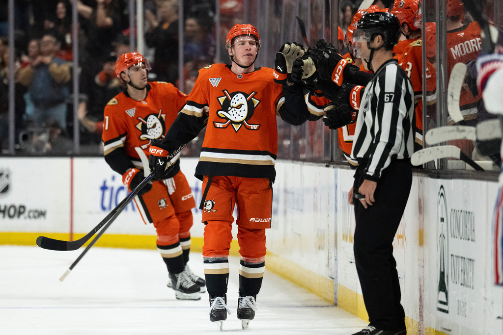 Anaheim Ducks defenseman Jackson LaCombe, center, celebrates with the bench after his goal during the second period of an NHL hockey game against the Montreal Canadiens, Friday, March 6, 2026, in Anaheim, Calif. (AP Photo/Kyusung Gong)