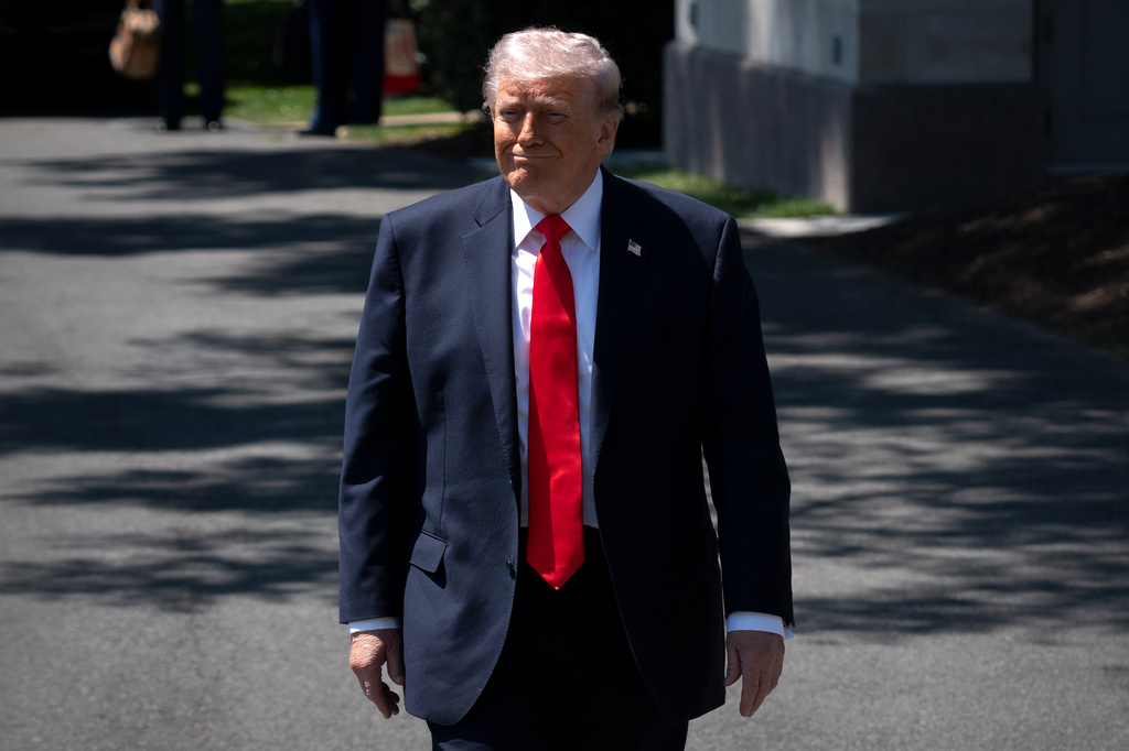 President Donald Trump walks to speak with reporters as he prepares to board Marine One on the South Lawn of the White House, Friday, May 1, 2026, in Washington. (AP Photo/Mark Schiefelbein)