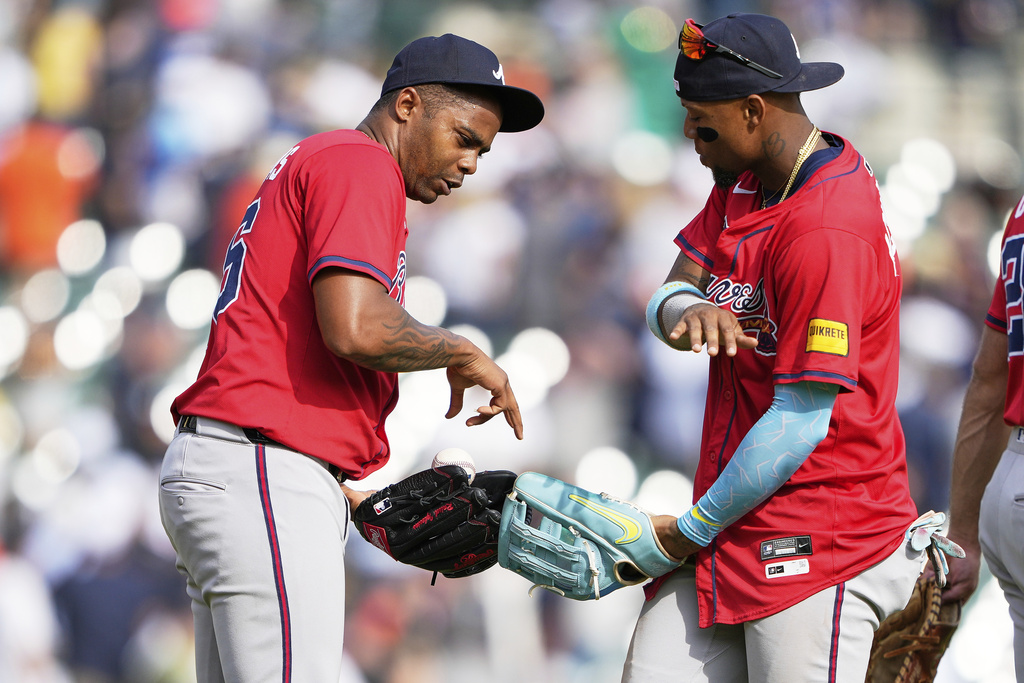 Atlanta Braves relief pitcher Raisel Iglesias, left, and right fielder Ronald Acuna Jr. celebrate after the team's win in a baseball game against the Detroit Tigers, Saturday, Sept. 20, 2025, in Detroit. (AP Photo/Ryan Sun)