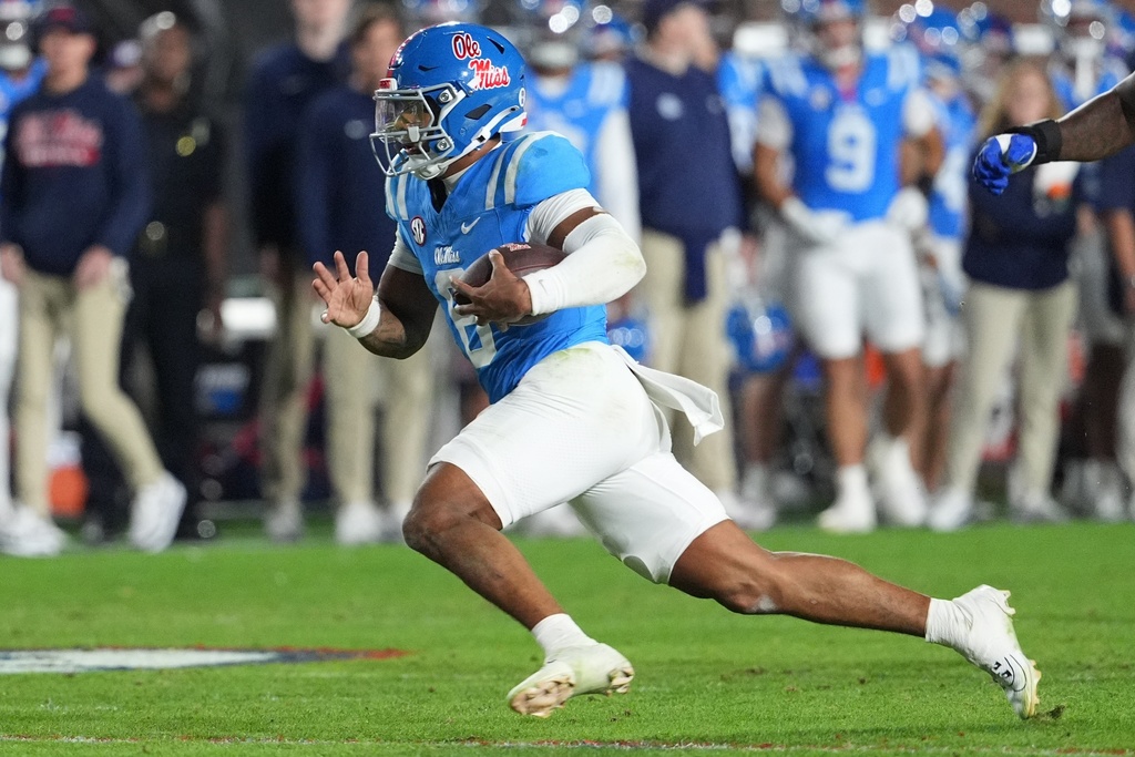 Mississippi quarterback Trinidad Chambliss rushes for a first down during the second half of an NCAA college football game against Florida, Saturday, Nov. 15, 2025, in Oxford, Miss. (AP Photo/Rogelio V. Solis)