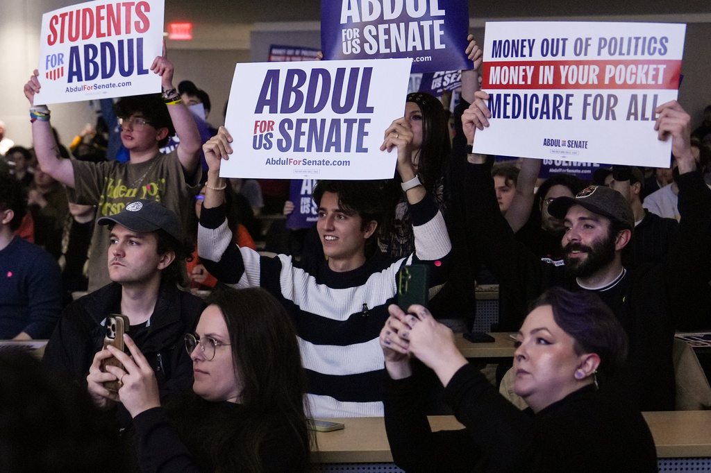 Attendees hold signs as Abdul El-Sayed, a progressive candidate in the Democratic primary for U.S. Senate in Michigan, speaks at a campaign event, Tuesday, April 7, 2026, at the University of Michigan in Ann Arbor, Mich. (AP Photo/Julia Demaree Nikhinson)