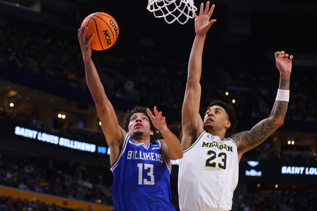 Saint Louis guard Dion Brown (13) goes up for a basket past Michigan forward Yaxel Lendeborg (23) during the second half in the second round of the NCAA college basketball tournament, Saturday, March 21, 2026, in Buffalo, N.Y. (AP Photo/Jeffrey T. Barnes)
