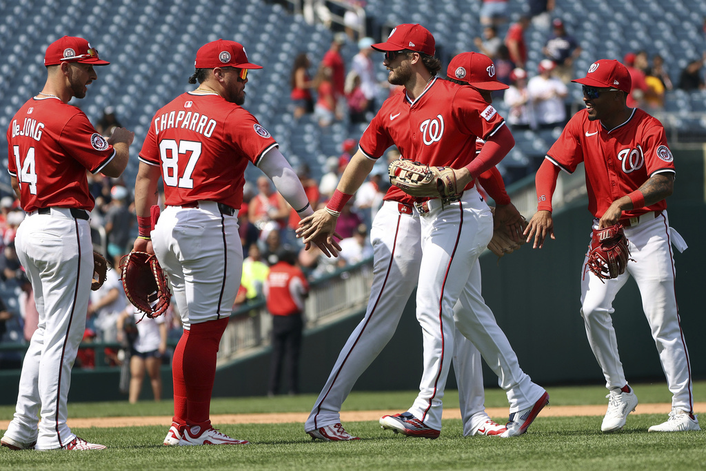 Washington Nationals players celebrate after a baseball game against the Pittsburgh Pirates, Sunday, Sept. 14, 2025, in Washington. (AP Photo/Daniel Kucin Jr.)