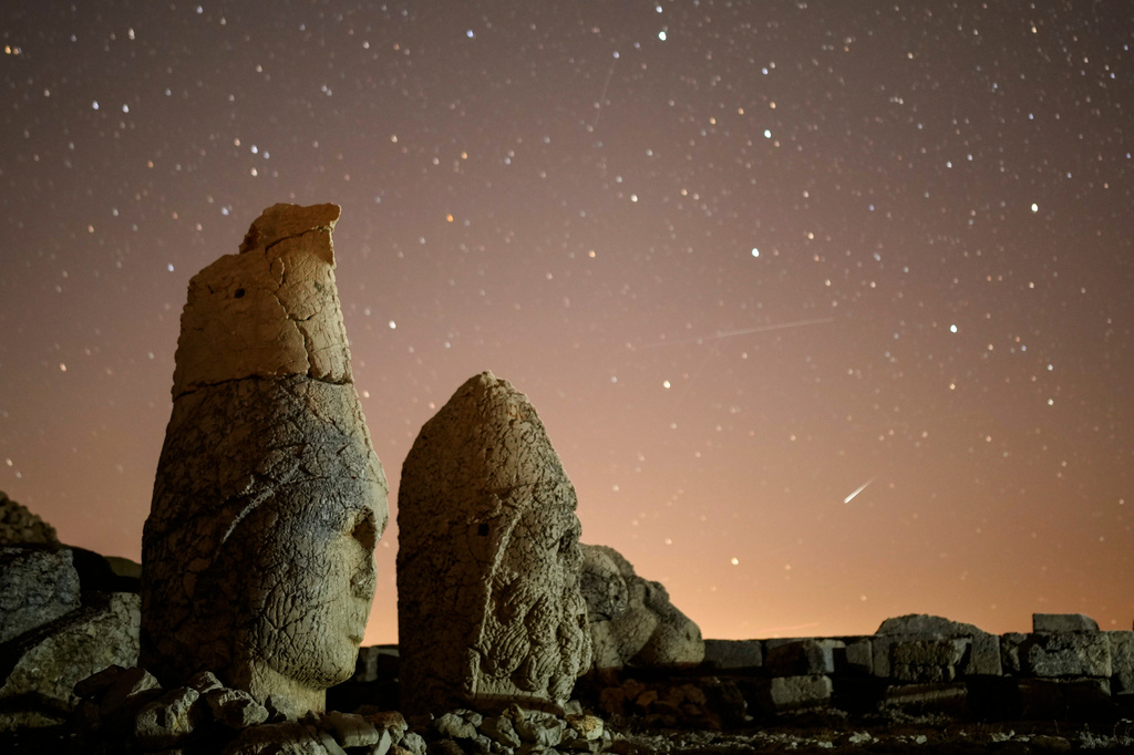 FILE - Ancient statues are seen during the Perseid meteor shower atop Mount Nemrut in southeastern Turkey, Sunday, Aug.11, 2024. (AP Photo/Emrah Gurel,File)