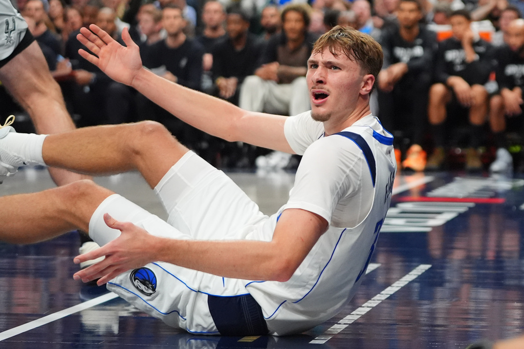 Dallas Mavericks forward Cooper Flagg reacts to a no-foul call during the second half of an NBA basketball game against the San Antonio Spurs in Dallas, Wednesday, Oct. 22, 2025. (AP Photo/LM Otero)