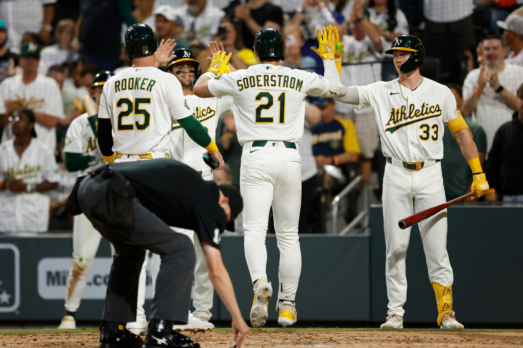 Athletics' Tyler Soderstrom (21) is greeted by teammates after hitting a three-run home run during the third inning of a baseball game against the Milwaukee Brewers, Monday, June 8, 2026, in Las Vegas. (AP Photo/Caroline Brehman)