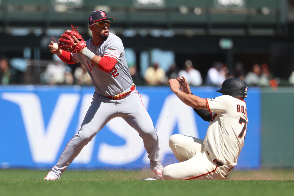 Los Angeles Angels second baseman Oswald Peraza (2) throws to first base as San Francisco Giants' Jesus Rodriguez, right, slides into second on a fielder's choice hit into by Willy Adames during the ninth inning of a baseball game in San Francisco, Sunday, July 26, 2026. (AP Photo/Jed Jacobsohn)