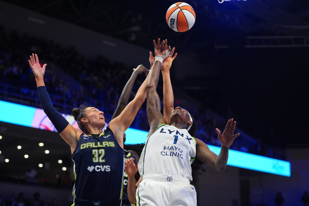 Minnesota Lynx forward Natasha Howard (1), Dallas Wings forward Jessica Shepard (32) and others jump for a rebound during the first half of a WNBA basketball game in Arlington, Texas, Sunday, June 28, 2026. (AP Photo/LM Otero)