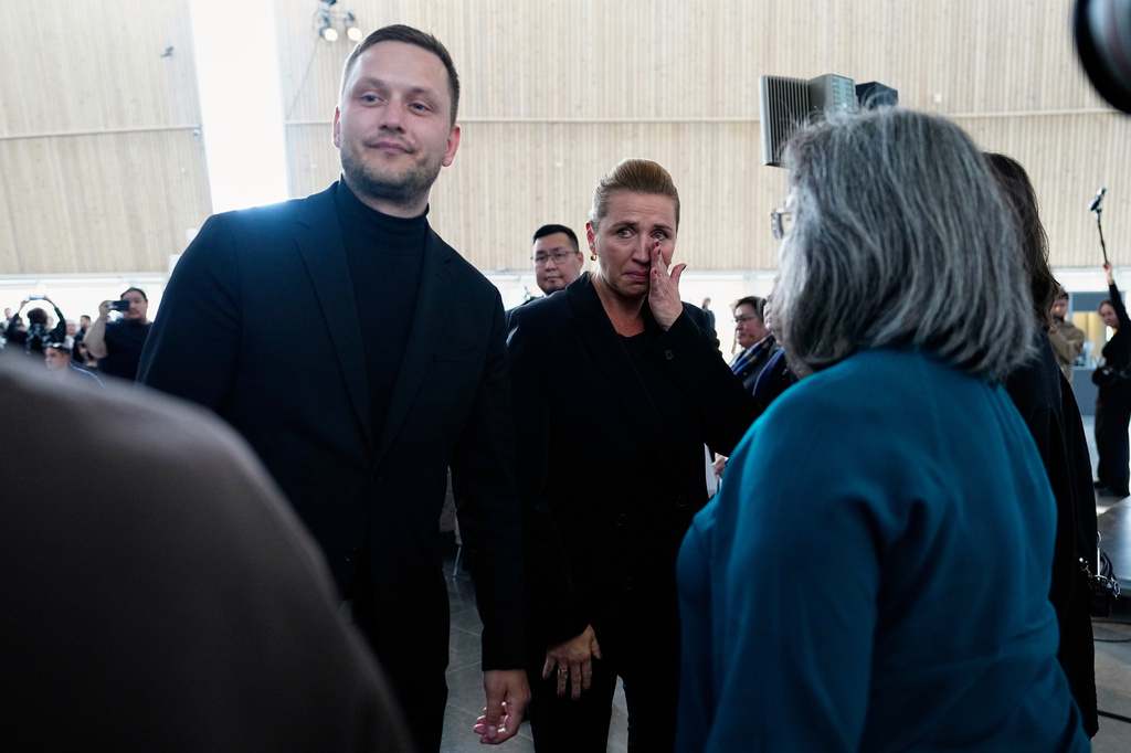 Greenland's Prime Minister Jens-Frederik Nielsen, left, and Danish Prime Minister Mette Frederiksen, center, greet and apologize to the affected women after a meeting in the cultural house Katuaq in Nuuk, Greenland, Wednesday Sept. 24, 2025. (Mads Claus Rasmussen/Ritzau Scanpix via AP)