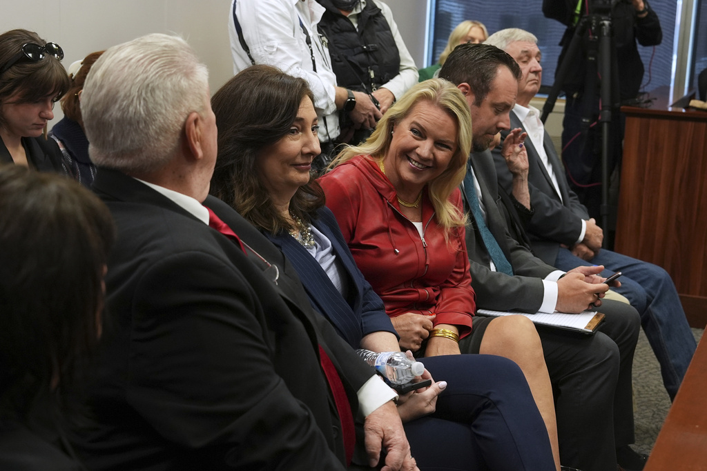 Clifford Frost, from left, Amy Facchinello, Meshawn Maddock, an unidentified attorney and Hank Choate appear during a district court hearing where a Michigan judge dismissed the criminal cases against 15 people accused of acting falsely as electors for President Donald Trump in the 2020 election Tuesday, Sept. 9, 2025 in Lansing, Mich. (AP Photo/Paul Sancya)
