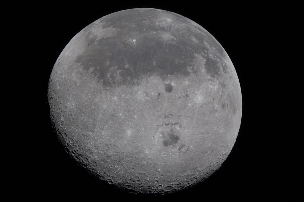 This image provided by NASA Monday, April 6, 2026, shows the Moon, the near side (the hemisphere we see from Earth) visible at the top half of the disk, identifiable by the dark splotches. At the lower center is Orientale basin, a nearly 600-mile-wide crater that straddles the Moon’s near and far sides. Everything below the crater is the far side. (NASA via AP)