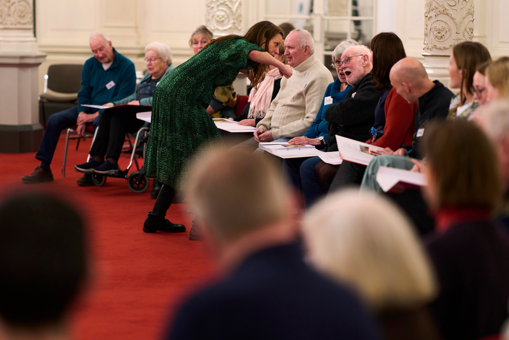 People many of them seniors with a form of dementia, join in the "singing circle" run by opera singer Maartje de Lint at the Concertgebouw concert hall in Amsterdam, on Feb. 24, 2026. (AP Photo/Peter Dejong)