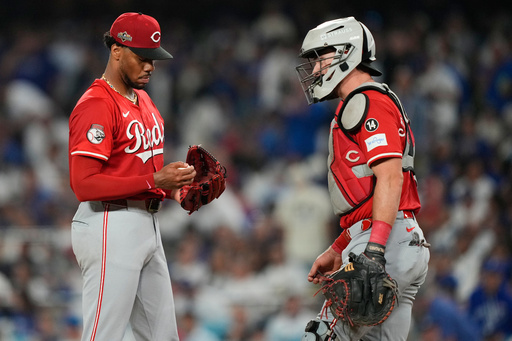 Cincinnati Reds pitcher Hunter Greene gets a visit to the mound from catcher Tyler Stephenson after Greene gave up a solo home run to Los Angeles Dodgers' Tommy Edman during the third inning in Game 1 of the National League Wild Card baseball playoff series Tuesday, Sept. 30, 2025, in Los Angeles. (AP Photo/Mark J. Terrill) Cincinnati Reds pitcher Hunter Greene gets a visit to the mound from catcher Tyler Stephenson after Greene gave up a solo home run to Los Angeles Dodgers' Tommy Edman during the third inning in Game 1 of the National League Wild Card baseball playoff series Tuesday, Sept. 30, 2025, in Los Angeles. (AP Photo/Mark J. Terrill)