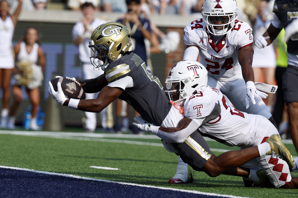 Georgia Tech wide receiver Malik Rutherford, left, dives for the end zone as Temple safety Avery Powell (29) defends during the first half of an NCAA college football game, Saturday, Sept. 20, 2025, in Atlanta. (AP Photo/Butch Dill)