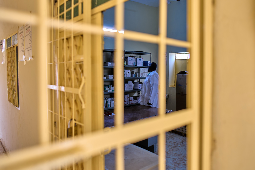 A staffer checks the pharmacy shelves at a public health clinic in Qoz Nafisa village, Khartoum state, Sudan, Wednesday, April 22, 2026. (AP Photo/Bernat Armangue)