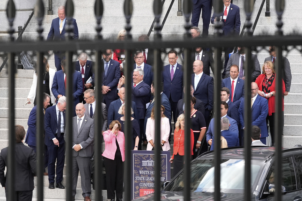 Members of the Indiana state legislation prepare to pose for a photo as they exit the Eisenhower Executive Office Building on the White House complex Tuesday, Aug. 26, 2025, in Washington. (AP Photo/Alex Brandon)