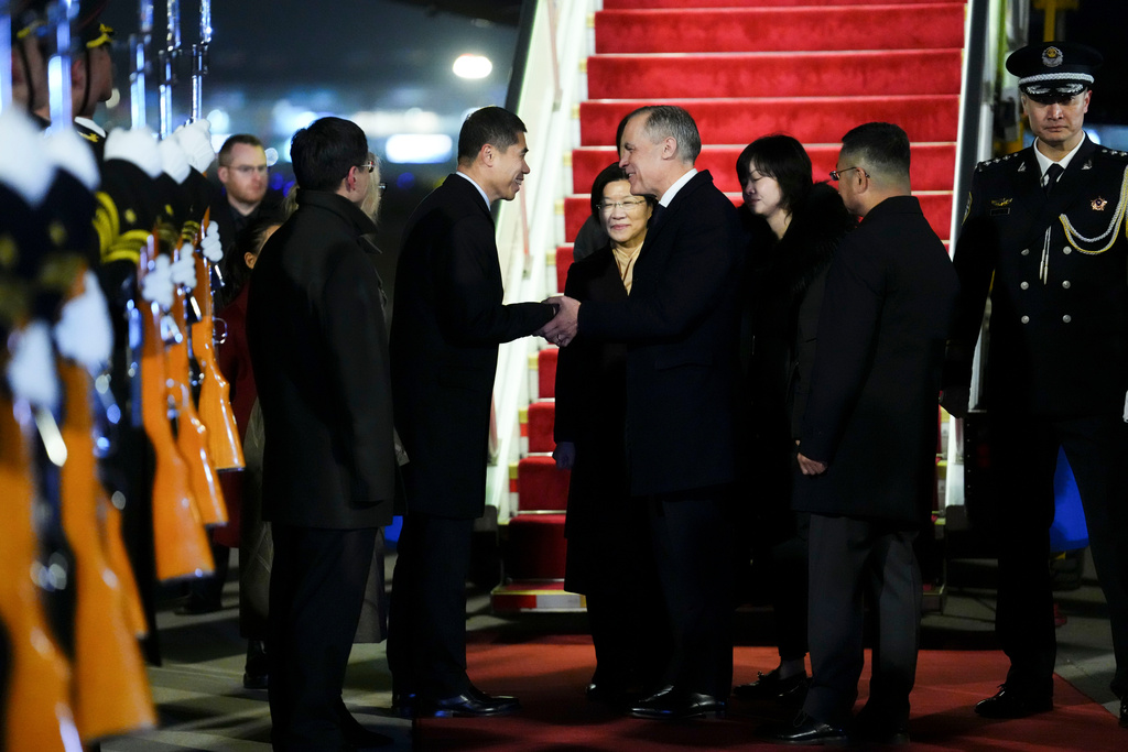 Prime Minister Mark Carney shakes hands with Chinese Ambassador to Canada Wang Di as he is officially welcomed to Beijing, China on Wednesday, Jan. 14, 2026. (Sean Kilpatrick /The Canadian Press via AP)