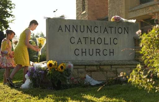 Ruth, right, and Sage place flowers at a memorial at Annunciation Catholic Church after Wednesday's school shooting, Thursday, Aug. 28, 2025, in Minneapolis. (AP Photo/Abbie Parr) Ruth, right, and Sage place flowers at a memorial at Annunciation Catholic Church after Wednesday's school shooting, Thursday, Aug. 28, 2025, in Minneapolis. (AP Photo/Abbie Parr)