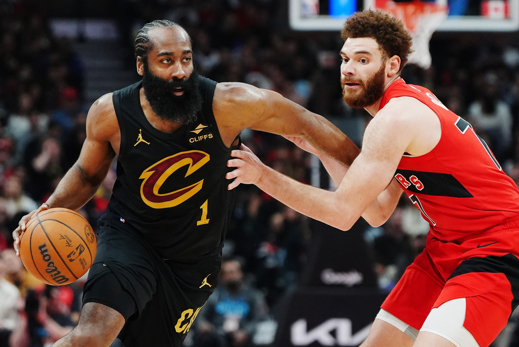 Cleveland Cavaliers' James Harden (1) drives past Toronto Raptors' Jamison Battle, right, during the first half of Game 6 in the first round of an NBA basketball playoffs series in Toronto, Friday, May 1, 2026. (Frank Gunn/The Canadian Press via AP)