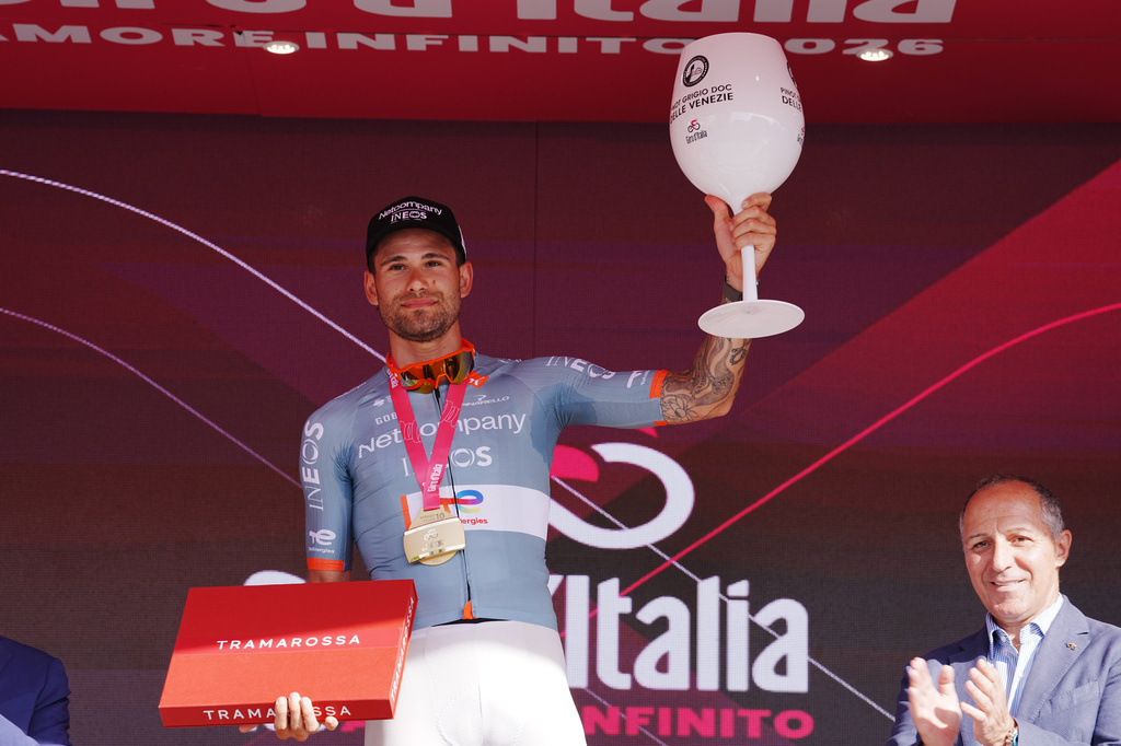 Italy's Filippo Ganna celebrates on the podium after winning the 10th stage of the Giro d'Italia cycling race from Viareggio to Massa, Italy, Tuesday May 19, 2026. (Gian Mattia D'Alberto/LaPresse via AP)