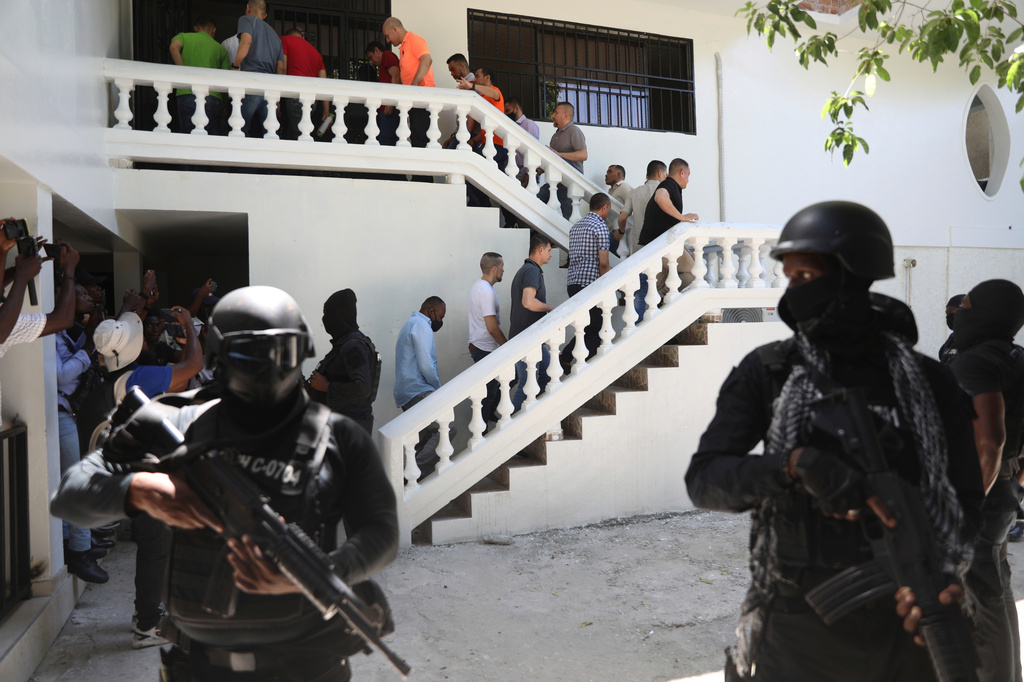 FILE - Colombians and Haitians who are accused of involvement in the 2021 assassination of Haitian President Jovenel Moise are escorted in handcuffs to their court hearing in Port-au-Prince, Haiti, May 26, 2025. (AP Photo/Odelyn Joseph, File)