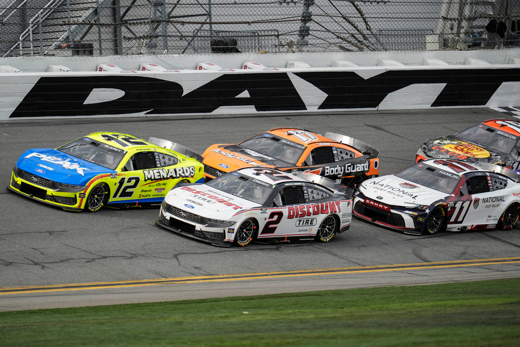 Cars move during the NASCAR Daytona 500 auto race at Daytona International Speedway, Sunday, Feb. 15, 2026, in Daytona Beach, Fla. (AP Photo/Mike Stewart)