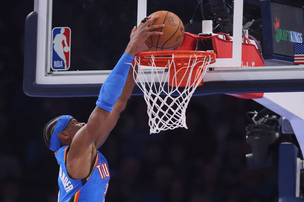 Oklahoma City Thunder guard Shai Gilgeous-Alexander dunks during the first half of an NBA basketball game against the Memphis Grizzlies, Monday, Dec. 22, 2025, in Oklahoma City. (AP Photo/Nate Billings)