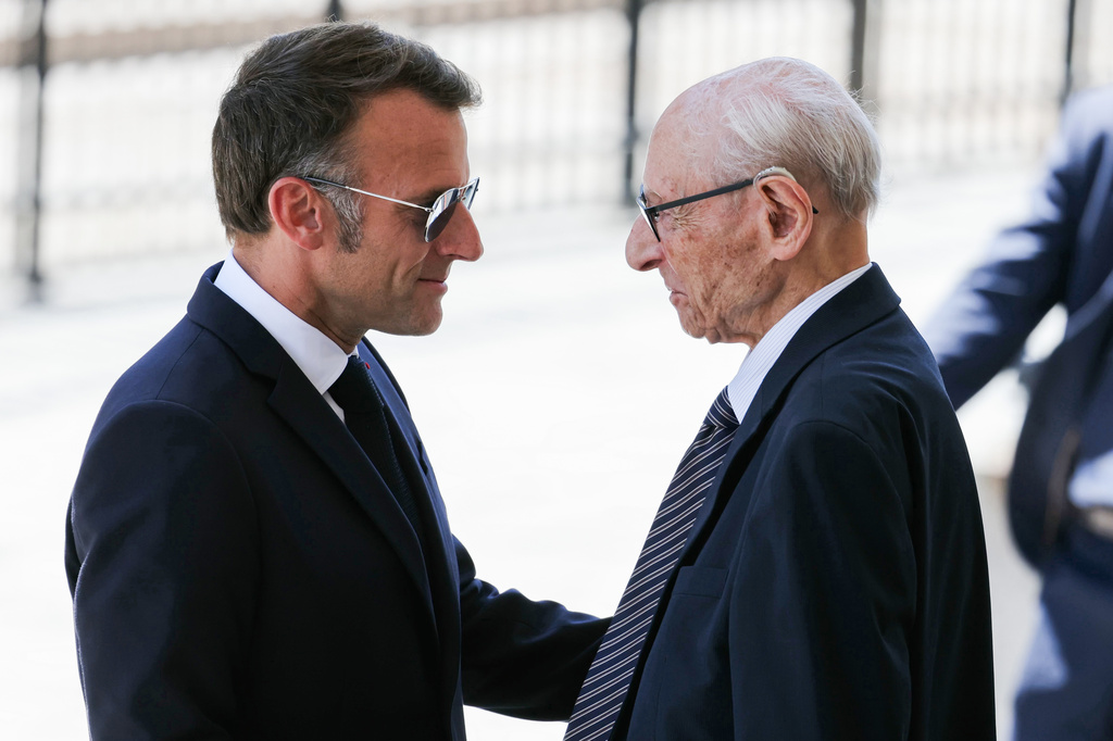 France's President Emmanuel Macron, left, with Charles Dreyfus grandson of Alfred Dreyfus during a tribute ceremony to Captain Alfred Dreyfus on the first national day dedicated to the recognition of his innocence by the Court of Cassation in 1906, and the fight against the resurgence of antisemitism, 120 years later, on the Ile de la Cite near the Cour de Cassation in Paris, Sunday, July 12, 2026. (Thomas Samson/Pool Photo via AP)