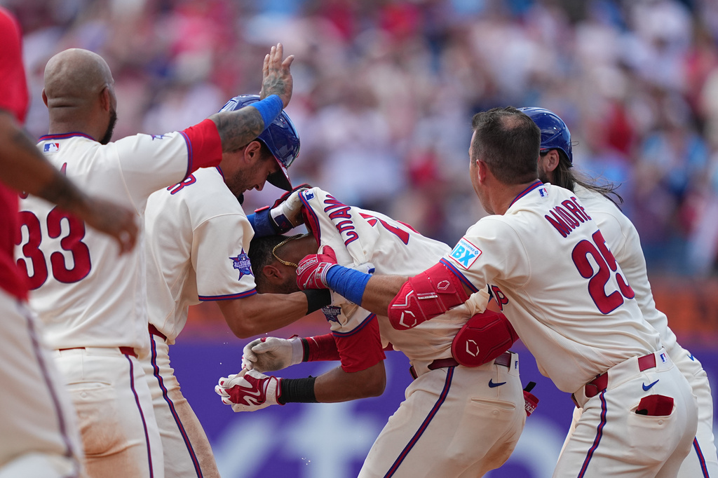 Philadelphia Phillies' Justin Crawford, center, celebrates teammates after they won a baseball game against the Washington Nationals, Wednesday, April 1, 2026, in Philadelphia. (AP Photo/Matt Rourke)